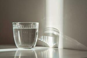 A glass of clean drinking water in the morning sun. photo