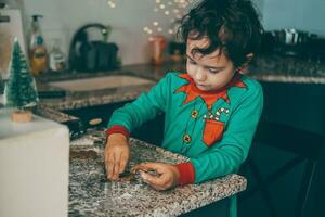 Festive vibes fill the air as loving mom and son spend quality time preparing Christmas gingerbread photo