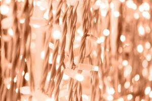 Background of garland lights in a delicate peach color. photo