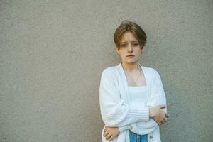 In her portrait, a teenage girl with short red hair reflects a mix of innocence and individuality photo