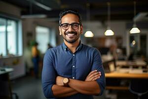 AI generated a young Indian male designer, engineer, architect who is wearing glasses and a blue shirt smiling standing in the office and looking at the camera photo