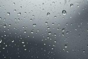 Rain, water drops on matte gray glass background photo