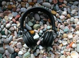 Black Headphones On A Round Colored Sea Stones Background As Symbol Of Rock Music photo