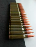 Vertical Photo Of Unitary Cartridges For Assault Rifle In Line On Black And White Background With Soft Focus On Edges