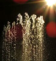 Fountain Splash In Ray Of Light Close Up photo