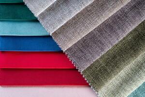 Multi colored set of upholstery fabric samples for selection, collection of textile swatches photo