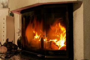Fire in a fireplace in the living room with accessories photo