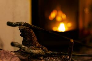 Fire in a fireplace in the living room with accessories photo