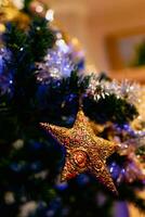 Gold star on christmas tree, decoration and ornament, celebration spirit photo