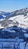 Free photo high angle shot of a beautiful mountain range covered with snow under the blue sky