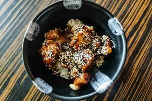chicken in teriyaki sauces with rice and sesame seeds photo