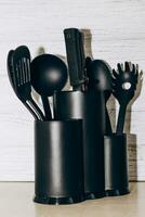 Kitchen tools plastic for multicooker on a wooden table in a dish organizer. photo