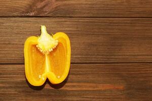 yellow sweet pepper on a wooden background, space for text. photo