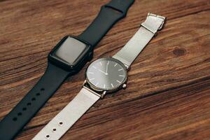 Black technological smart watches and ordinary mechanical watches with a dial. photo