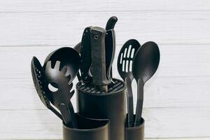 Kitchen tools plastic for multicooker on a wooden table in a dish organizer. photo