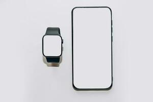 A black technological smart watch has a white screen for a place for text with a phone. photo