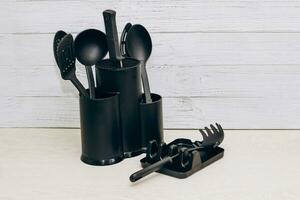 Kitchen tools plastic for multicooker on a wooden table in a dish organizer. photo