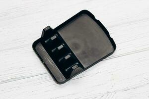 Plastic black coaster for dishes, a handy thing in the kitchen, space organization photo