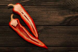 Red capi pepper on a wooden background, space for text. photo