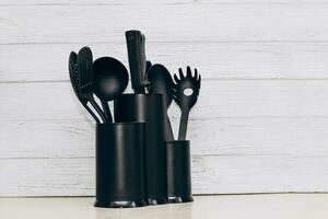 Kitchen tools plastic for multicooker on a wooden table in a dish organizer. photo