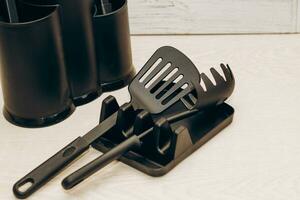 Kitchen tools plastic for multicooker on a wooden table in a dish organizer. photo