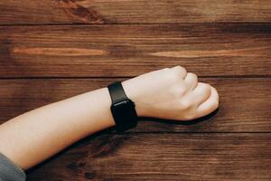 Black technological smart watch in hand. photo