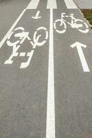 A bicycle path on the asphalt, a bicycle is drawn. photo