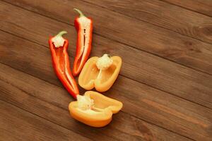 Red pepper Kapi with yellow sweet pepper on a wooden background, space for text. photo