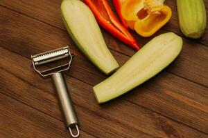 Chopped vegetables, carrots, peppers, zucchini on a vegetable peeler. photo