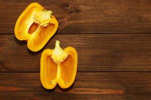 yellow sweet pepper on a wooden background, space for text. photo