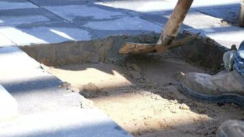 workers take stones with shovel to put into pit on road video