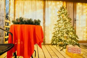 decorated Christmas tree on wooden deck, creating warm ambiance for festive occasion photo