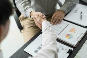 Businessman shaking hands successful making a deal. mans handshake. Business partnership meeting concept photo