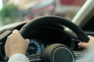 Woman driving car. girl feeling happy to drive holding steering wheel and looking on road photo