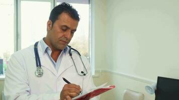 Smart doctor makes notes in his notebook video