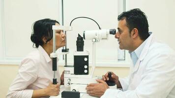 A skilled doctor examines the patients eyes with a device video