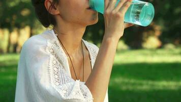 Girl is drinking water between diong yoga video