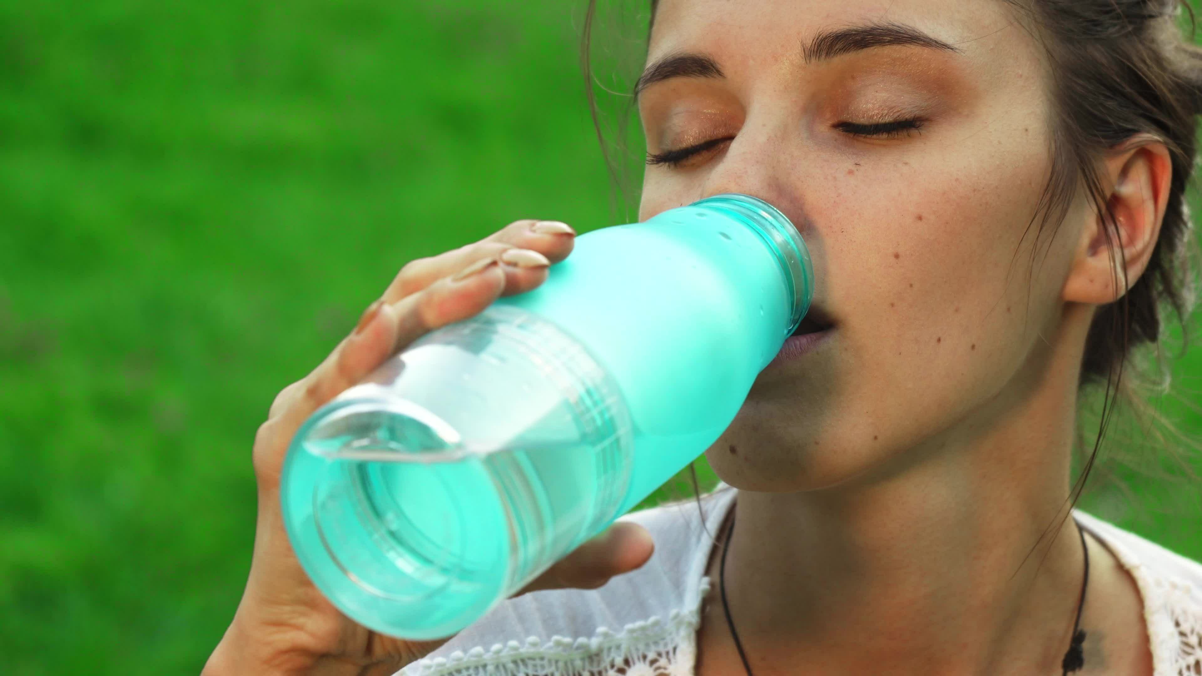 Beautiful young girl is drinking water while doing yoga 35314354 Stock