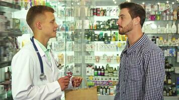 Doctor giving a package with pills to patient video