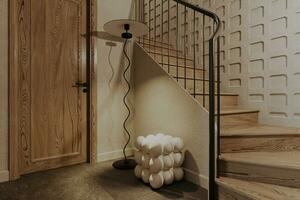 A floor stand lamp and bubble candle standing by the upstairs. photo