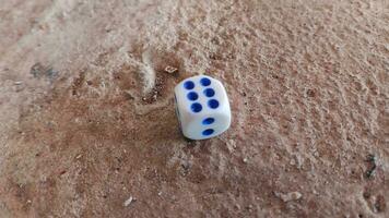 Dice placed on concrete floor surface, selective focus. photo