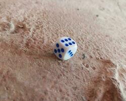 Dice placed on concrete floor surface, selective focus. photo