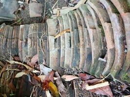 Old asian house roof tile texture, Close up view of old weathered roof photo