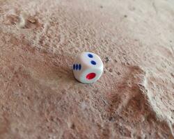 Dice placed on concrete floor surface, selective focus. photo