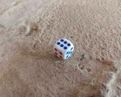 Dice placed on concrete floor surface, selective focus. photo