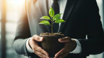 ai generado un empresario sostiene un joven árbol en su manos, simbolizando crecimiento y sustentabilidad en negocio. generativo ai foto