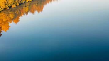 AI generated Aerial view of autumn forest on the lake. Beautiful nature background. copy space photo