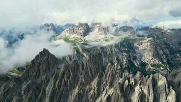 aereo Visualizza di cadeni di misurina montagne con tre cime di lavare montagne nel il sfondo durante un' soleggiato giorno con alcuni nuvole. dolomiti, Italia. drammatico e cinematico paesaggio. video