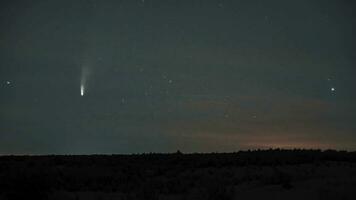 Comet NEOWISE moves across the night sky among the stars. Timelapse 4K video