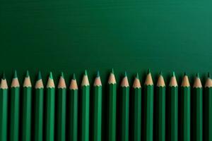 AI generated Green shades pencils row on greenery background. Generate ai photo
